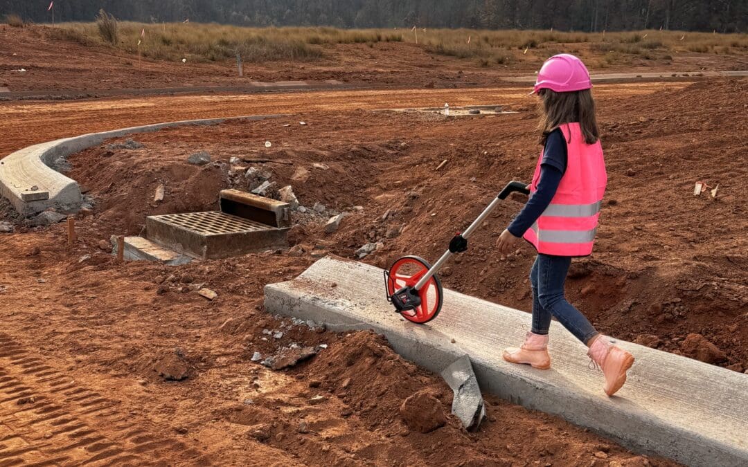 Kennie Raby, seven, uses an estimator tool on a job site.
